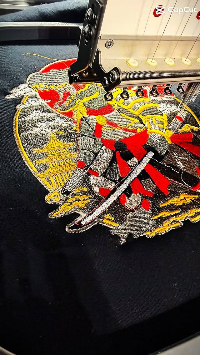 Samurai warrior embroidered in red, gold, and silver thread on a black t-shirt by Raging Thunder Apparel